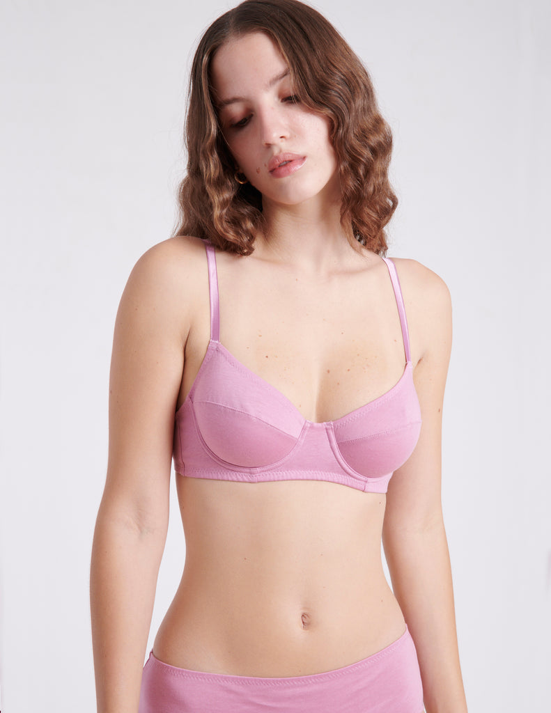 detail of woman wearing pink underwire bra