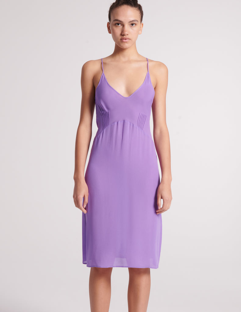 The silk cadel slip in purple worn on a model.